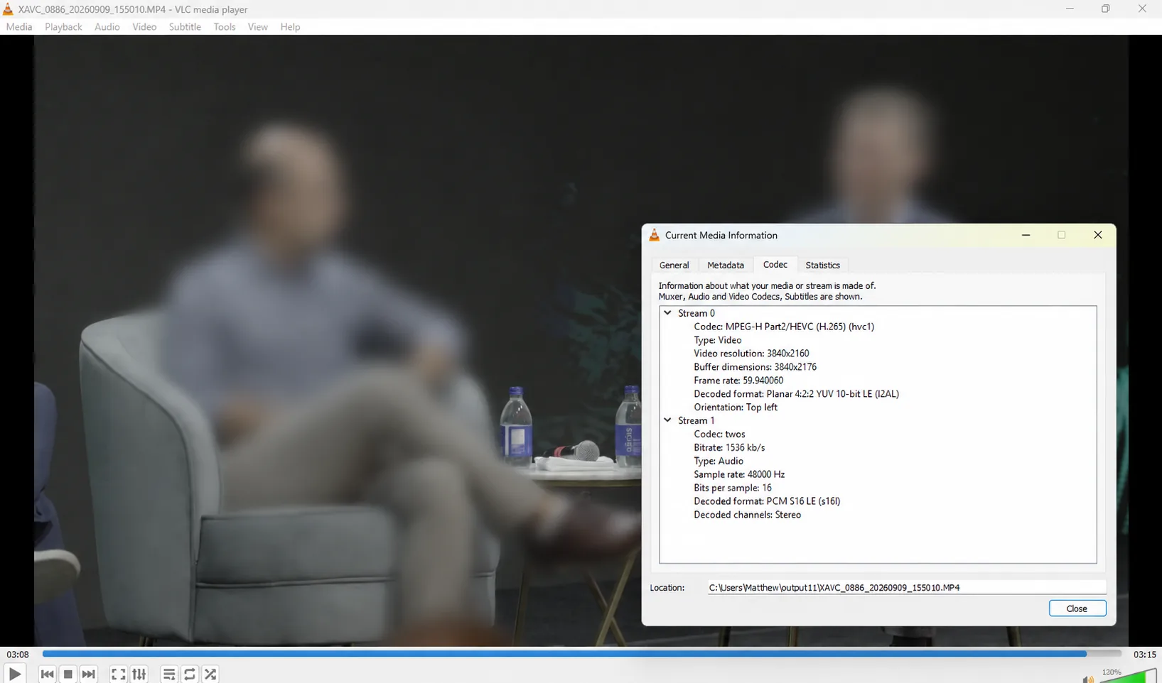 Recovered Sony FX3 XAVC HS HEVC video playing in VLC with people blurred for privacy and codec information visible.