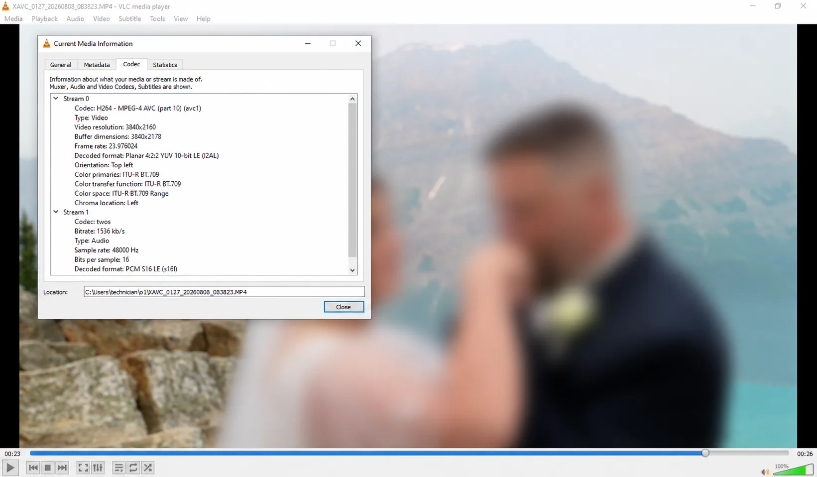 Recovered Sony ZV-E1 wedding video playing in VLC with the people blurred for privacy and codec information showing H.264 AVC, 3840 by 2160 video, 23.976 frames per second, 10-bit 4:2:2 decoded output and 48 kHz PCM audio.